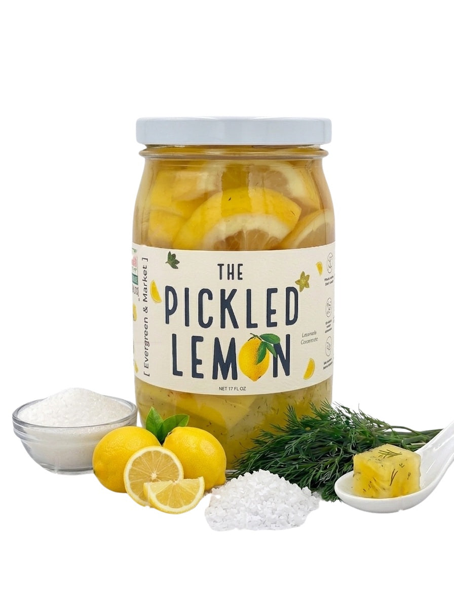 Jar of The Pickled Lemon by [PICKLES] with fresh lemons and dill