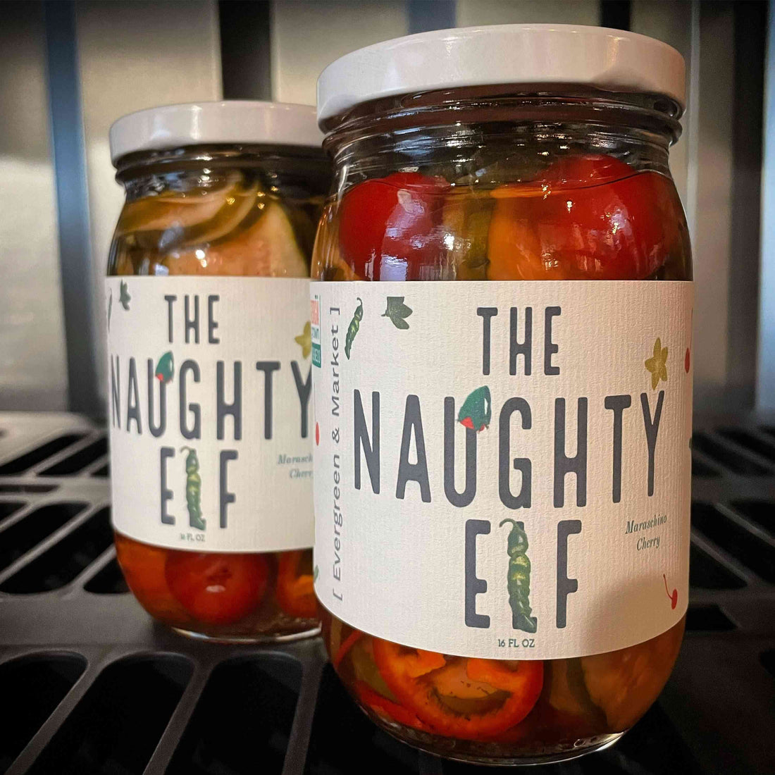 Two jars of The Naughty Elf, filled with red and green peppers