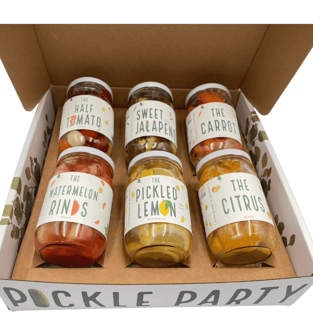 Gift box with white exterior and green leafy pattern, labeled '[PICKLES]' and 'PICKLE PARTY' for a unique pickle gift set.