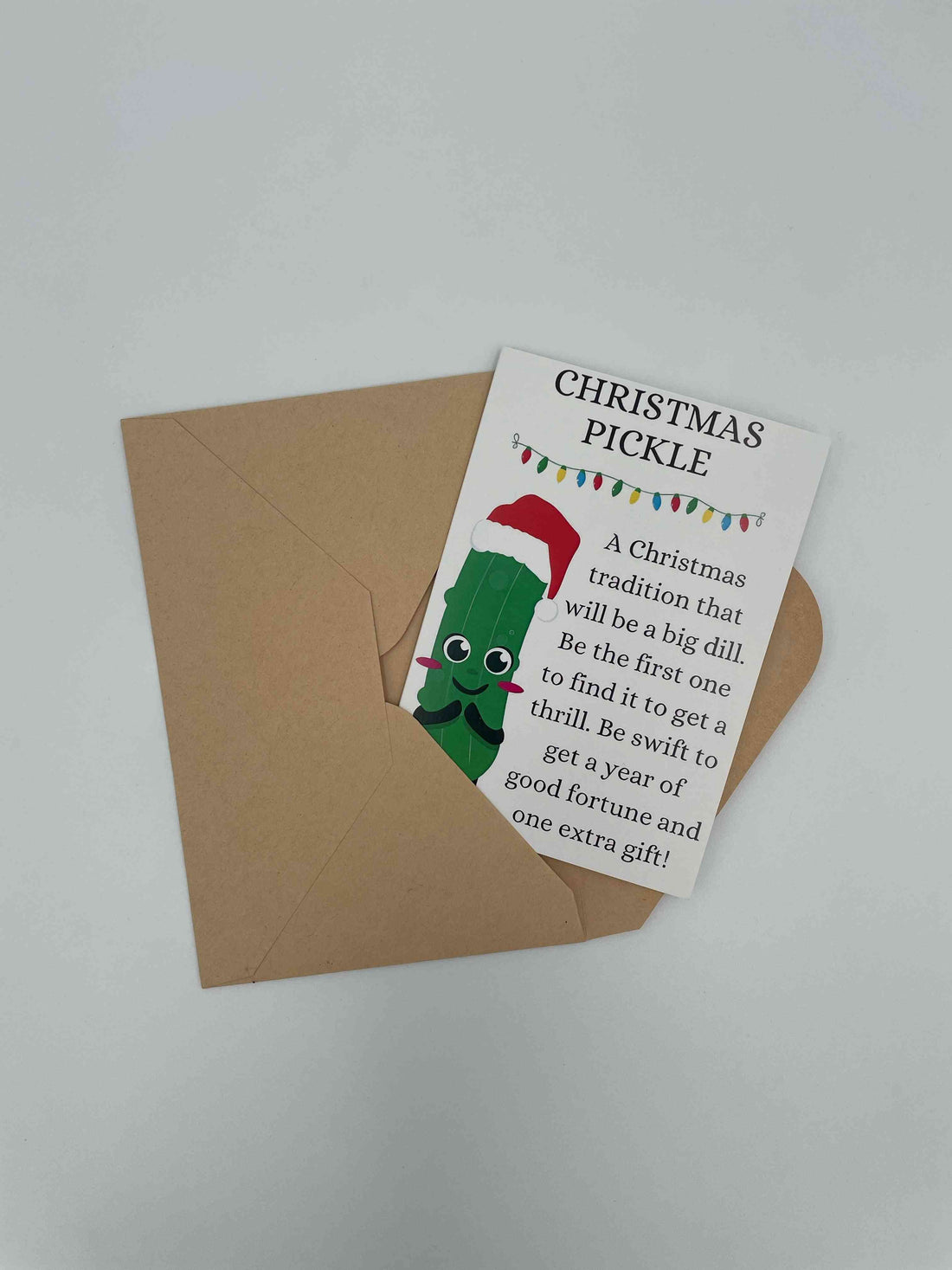 Christmas Pickle card telling the tradition of hiding a pickle ornament on the tree, on a kraft envelope